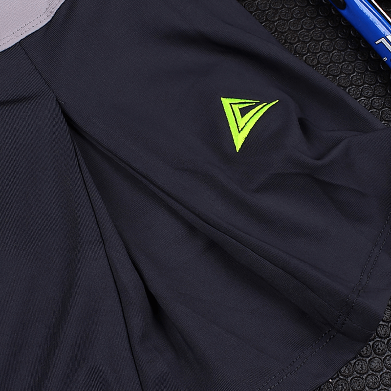 Close-up of a navy breathable tennis skirt-shorts for women with pocket and green logo, ideal for sports like tennis and volleyball.